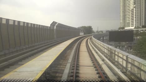 kuala lumpur, malaysia -july 8, 2019: passengers record the mass rapid transit movement from the back of the train