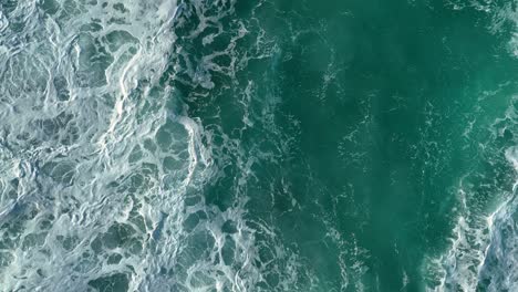 Above-View-Of-Sea-Waves-With-Splashes-And-Foam-Crash-Over-The-Shore