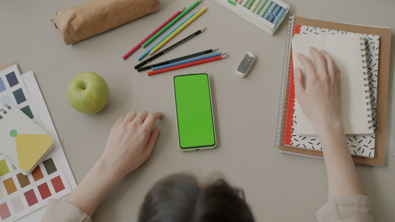 Student Workspace with Green Screen Phone and Supplies