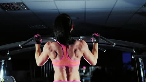 video with studio light muscular woman trains muscles of the back prores hq 422 10 bit video