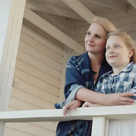 A-woman-with-a-child-on-the-veranda-of-her-country-house-1