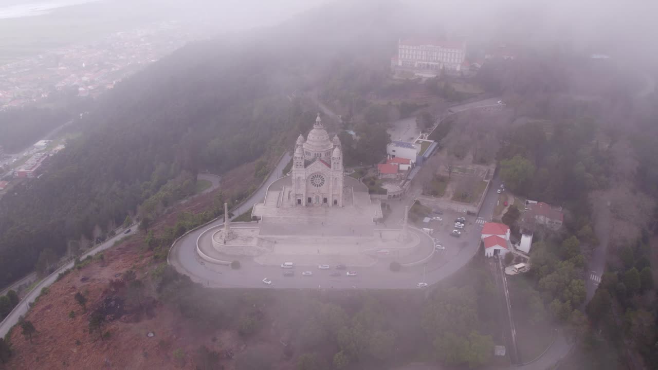 Flying through low clouds at Viana do Castelo, Santu&aacute;rio de Santa Luzia, aerial