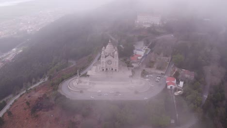 Flying-through-low-clouds-at-Viana-do-Castelo,-Santuário-de-Santa-Luzia,-aerial