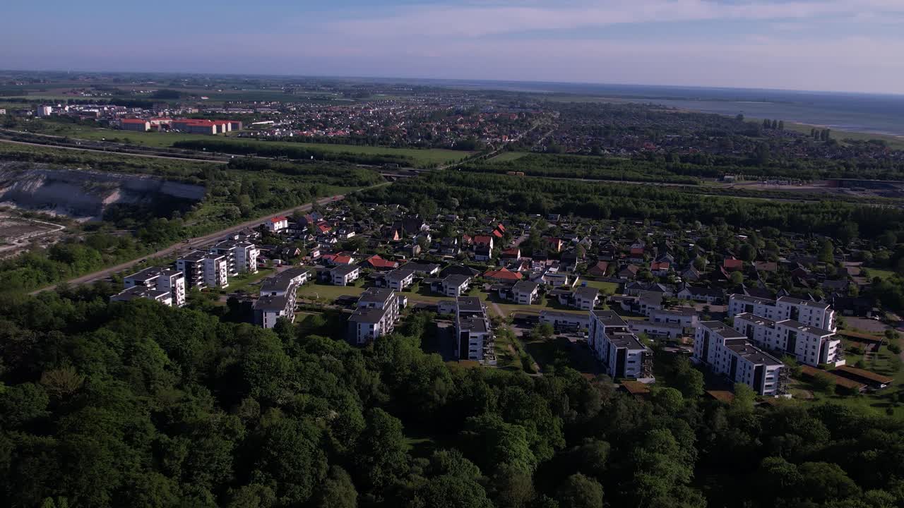 A aerial view of modern Malmö apartments, showcasing the city’s architecture and vibrant urban landscape. The drone glides smoothly over residential buildings.