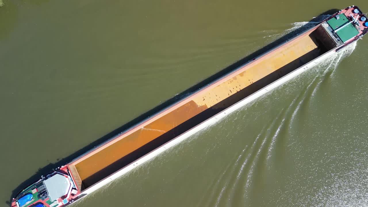 Aschaffenburg in Germany from above and river Main with sand carrier vessel slowly flowing