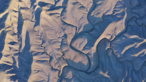 aerial birds eye descending over utah badlands