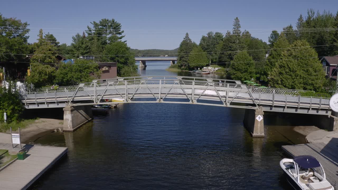 Narrow steel bridge with cars and pedestrians crossing over river in Dorset Ontario Canada