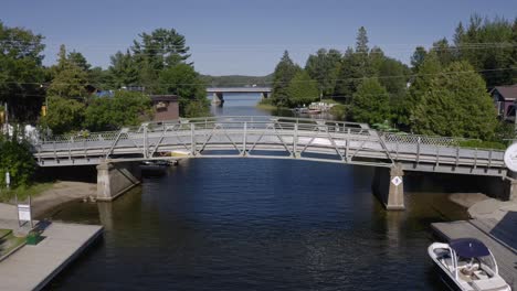 narrow steel bridge with cars and pedestrians crossing over river in dorset ontario canada