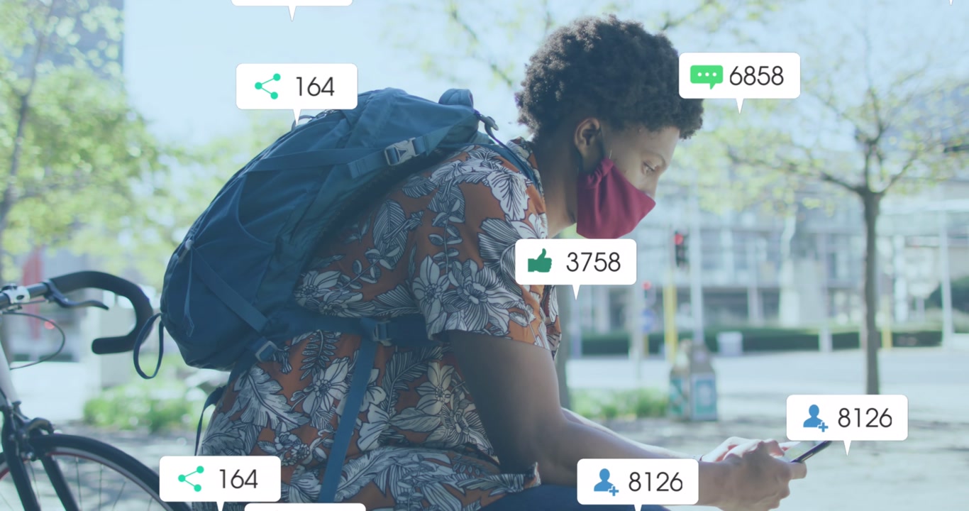 Animation of social media icons with growing numbers over african american man using smartphone