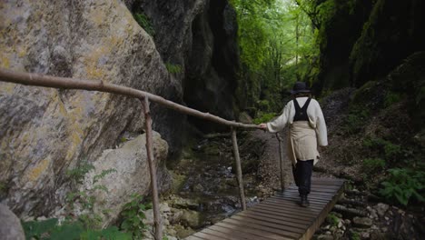 woman hiking through a rocky canyon