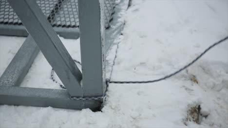 securing a metal structure in the snow