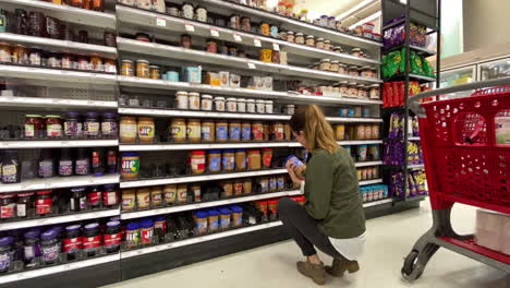 woman trying to pick out peanut butter at her local target store