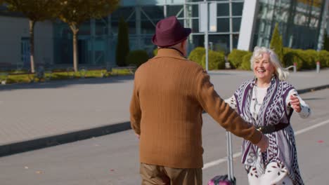 senior old husband and wife retirees tourists reunion meeting in airport terminal after traveling