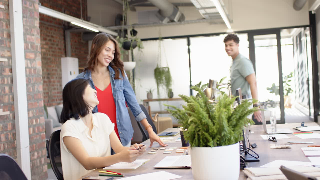 Collaborating on interior design project, multiracial colleagues discussing ideas in office space