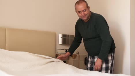 gay couple talking while making bed in the morning