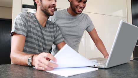 Happy-homosexual-couple-using-computer