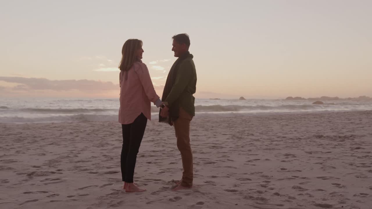 Active senior couple standing on beach