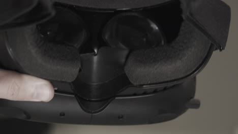 look at front of virtual reality vr - ar headset, turn over and wear