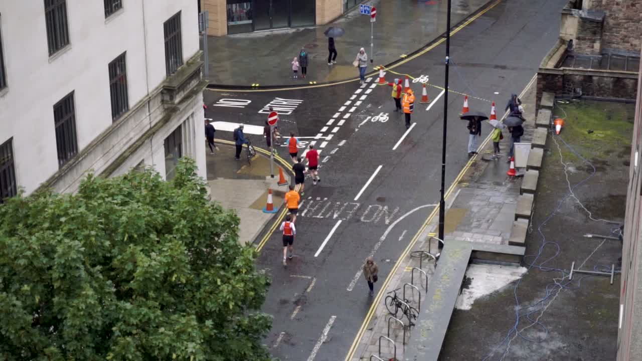 Slow motion of runners turning street corner in race