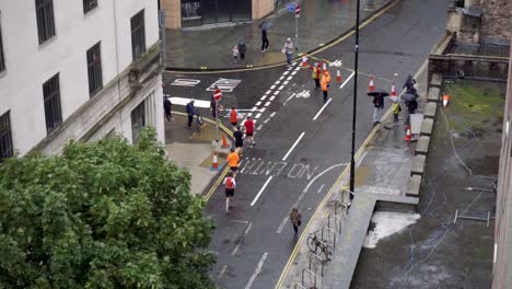 slow motion of runners turning street corner in race