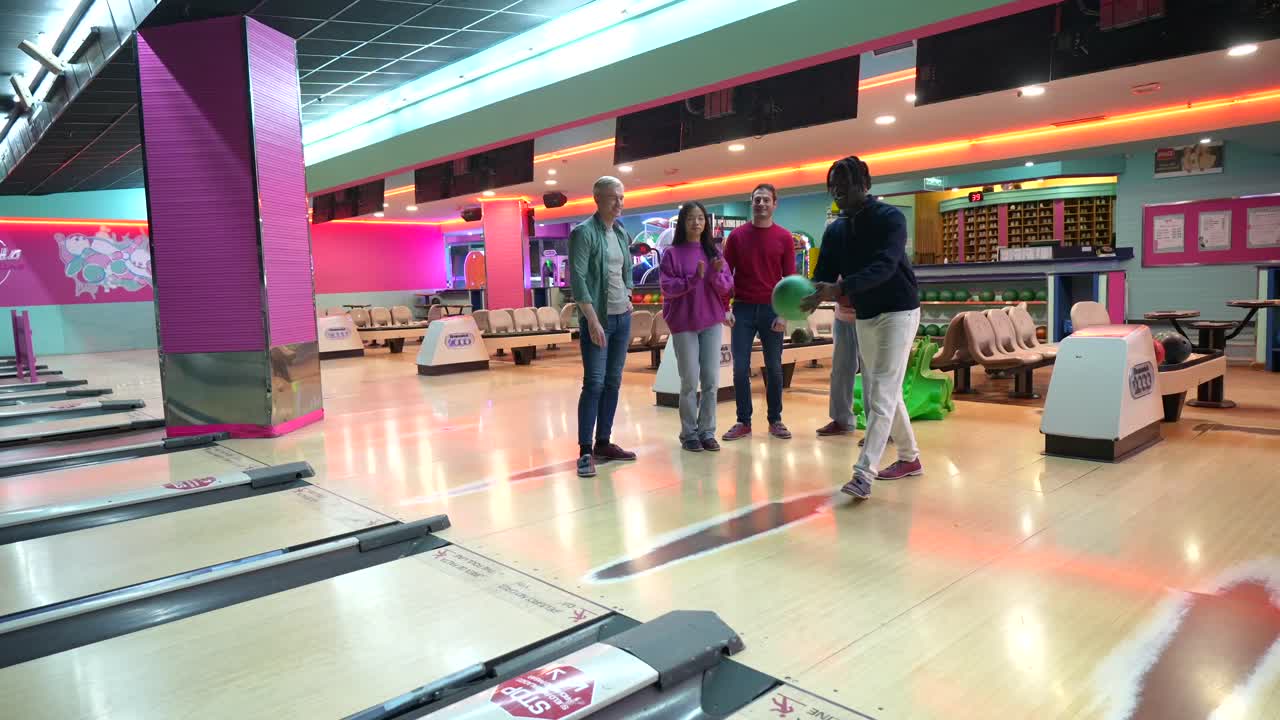 People Enjoying Bowling at a Bowling Alley
