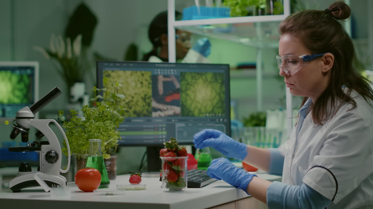 Pharmaceutical scientist looking at glass with strawberry