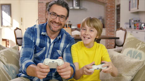 father and son playing video games together