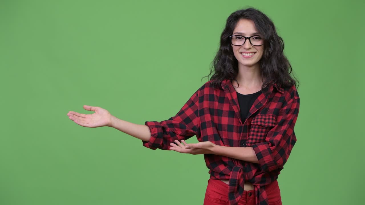 Young beautiful businesswoman showing something