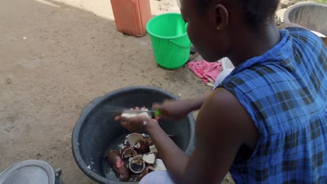 black african woman preparing traditional fufu food chopping vegetable in the street