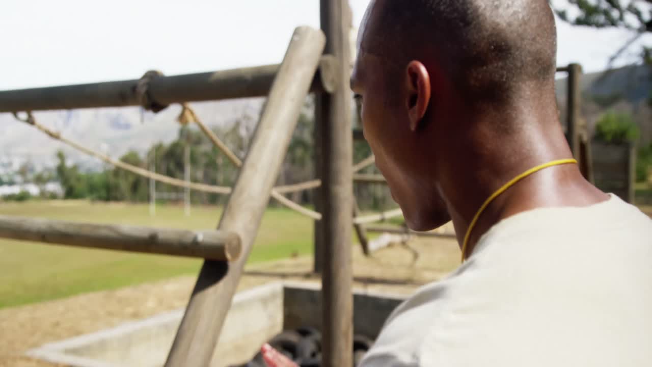 Military soldier crossing the rope during obstacle course 4k