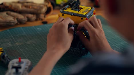 child building a lego robot toy