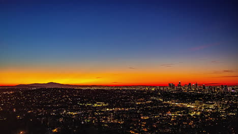 a beautiful orange-yellow sunrise over los angeles as seen from kenneth hahn view point