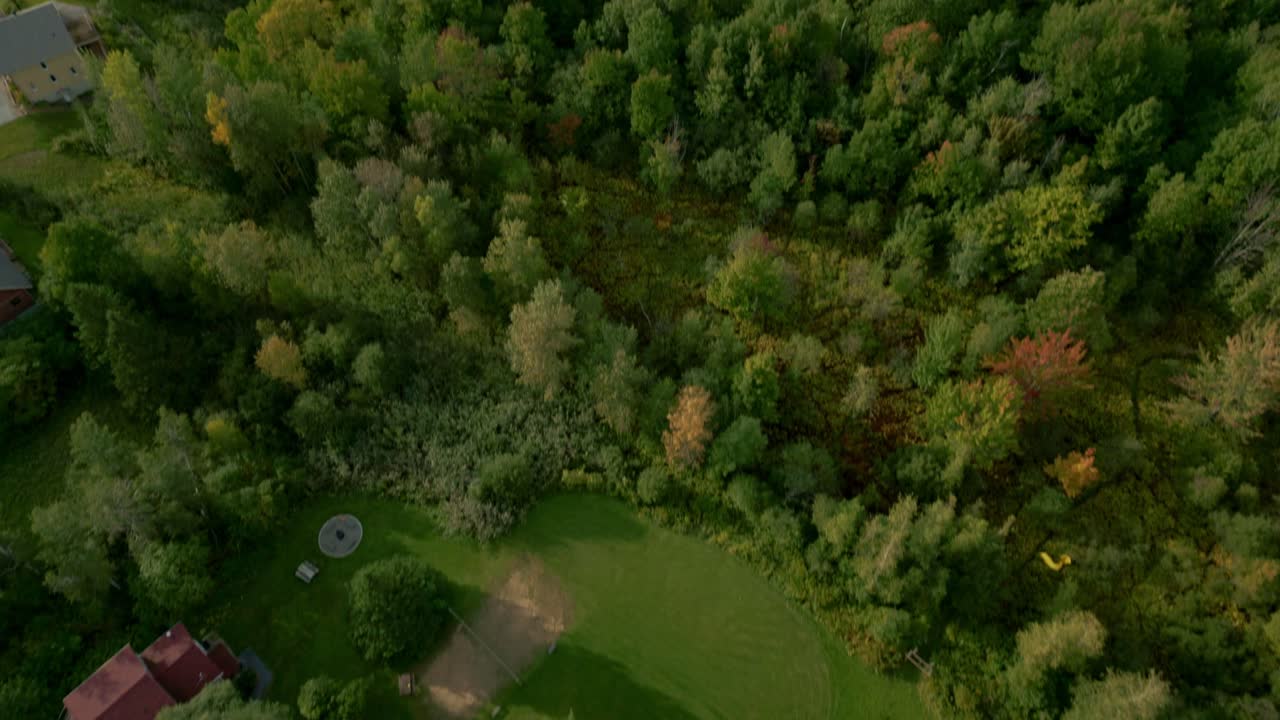 Drone moves towards from luxury home and pool to breathtaking aerial view of Sutton, Quebec’s lush green landscape, nature’s beauty and serene countryside.