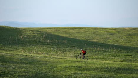 man trail running in a green field