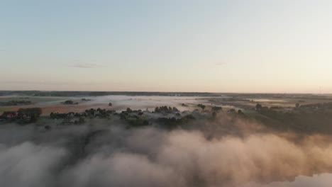 flying over river nemunas  with fog in the early morning near raudondvaris, lithuania. aerial view