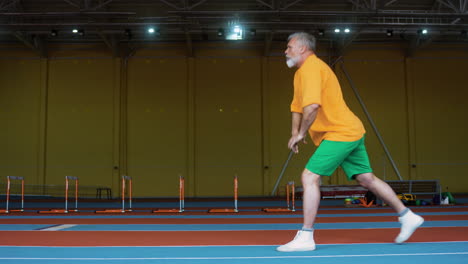 senior man stretching indoors