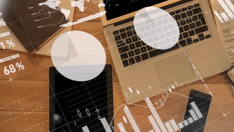 animation of financial data processing over laptop and tablet on desk