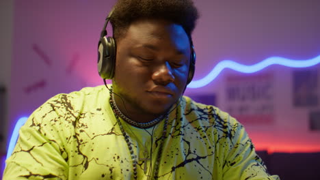 black man creating music at studio production desk