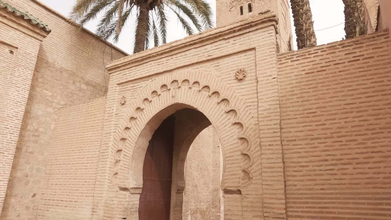Koutoubia mosque tower tilt down to ornate archway door entrance