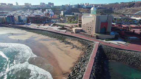 aerial view of coastal city with beach and modern building