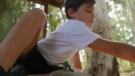 a boy playing with plastic army figurines at the park on a sunny day