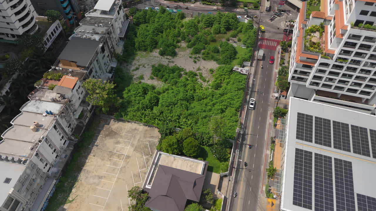 Above View Of Road Traffic And High Rise Buildings In Phrom Phong, Bangkok, Thailand. Aerial Drone Shot