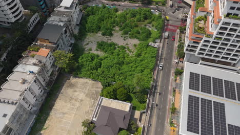above view of road traffic and high rise buildings in phrom phong, bangkok, thailand. aerial drone shot