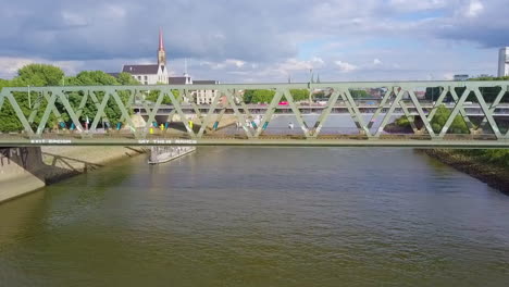 train traveling at the railroad bridge over weser river in bremen, germany