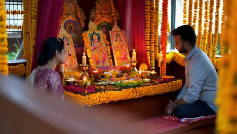 couple praying at a hindu shrine