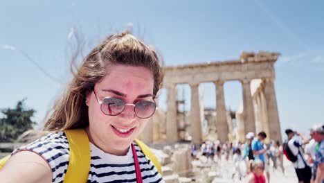 woman vlogging at the crowded acropolis site, athens, greece