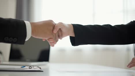 close up two business partner shaking hands successful business deal in modern office. successful business partnership agreement.