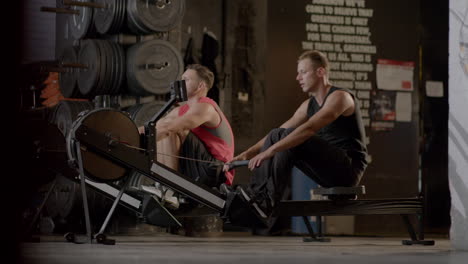 men working out on rowing machines in a gym