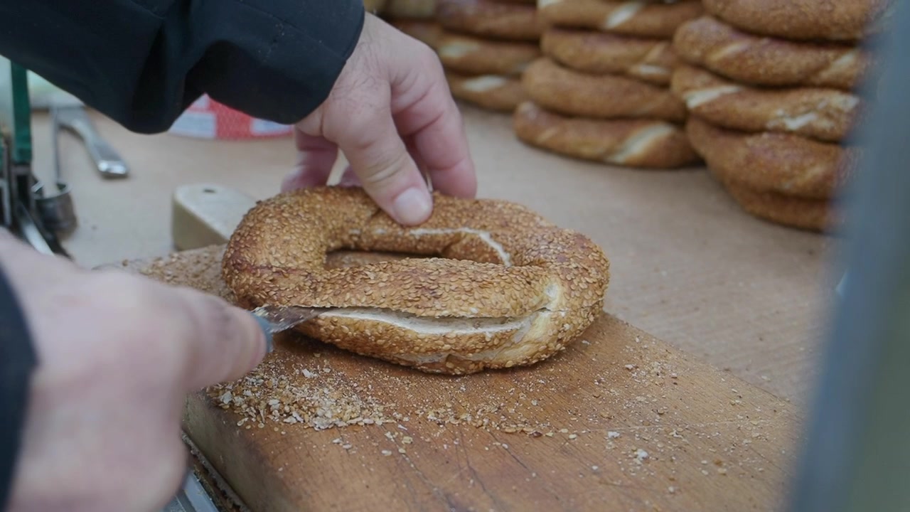 Street Vendor Slicing a Fresh Turkish Simit Bread