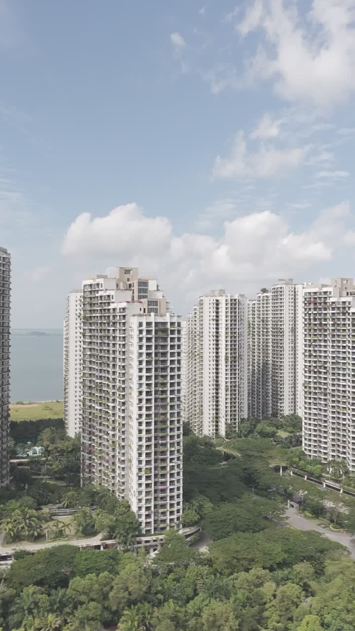 Vertical aerial shot of the Ataraxia towers in Forest City as the drone moves sideways captured in dlog m color profile